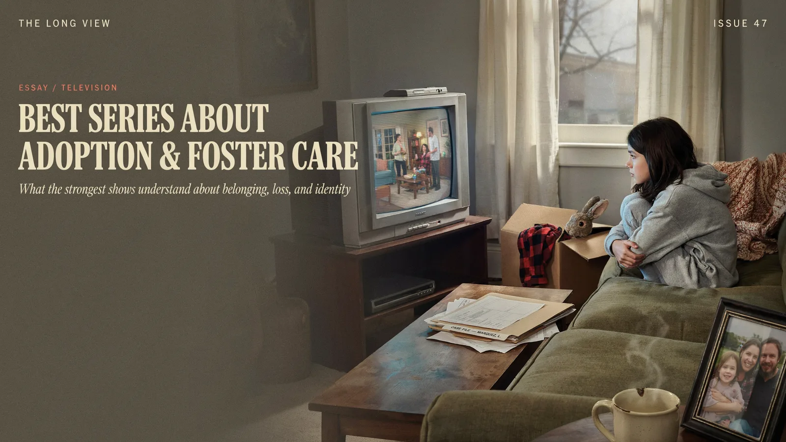 A girl hugging her knees on a couch watching television beside a moving box and a stuffed rabbit, titled Best Series About Adoption and Foster Care.